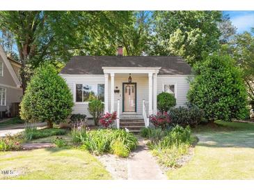 Charming single-story home with a welcoming front porch and beautifully landscaped front yard at 708 Mills St, Raleigh, NC 27608