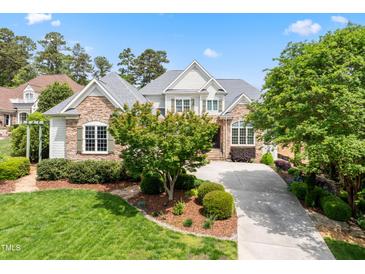 Charming stone and siding home with a well-manicured front lawn and a paved driveway leading to the entrance at 77 Ruffed Grouse, Chapel Hill, NC 27517