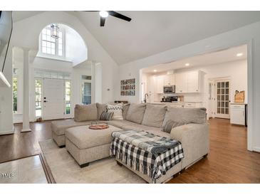 Inviting living room with vaulted ceiling, hardwood floors and view to the kitchen at 100 Bradborne Cir, Clayton, NC 27520