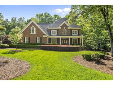 Beautiful brick home with manicured lawn and lovely landscaping at 10825 Rondeau Woods Ct, Raleigh, NC 27614