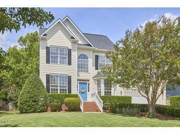 Charming two-story home with a well-manicured lawn and a welcoming blue front door at 109 Hogan Glen Ct, Chapel Hill, NC 27516