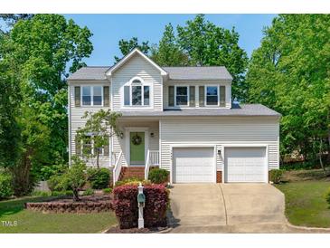 Charming two-story home boasts a landscaped front yard and a convenient two-car garage at 1095 Vauxhall Dr, Apex, NC 27502