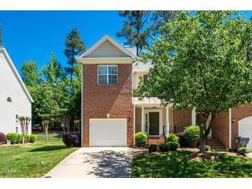 Charming brick two-story home with well-manicured lawn and attached garage under a sunny blue sky at 111 Florians Dr, Holly Springs, NC 27540