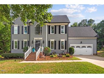 Beautiful two-story home featuring a manicured lawn, attached two-car garage, and classic curb appeal at 116 Dallavia Ct, Morrisville, NC 27560