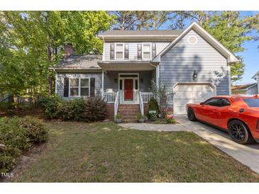 Charming two-story home with gray siding, brick accents, and a well-manicured front yard at 120 Foley Dr, Garner, NC 27529