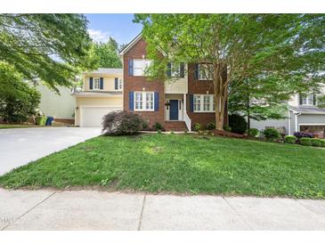 Charming two-story home boasts a brick and siding facade, complemented by a well-manicured lawn at 13017 Townfield Dr, Raleigh, NC 27614