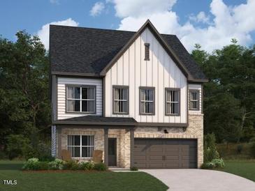 Charming two-story home featuring a mix of siding and stone with an attached two-car garage at 1405 Malcus Ct # 59, Fuquay Varina, NC 27526