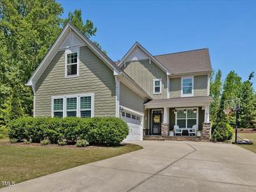 Charming two-story home featuring a well-manicured lawn, inviting front porch and a spacious driveway at 1701 Bodwin Ln, Apex, NC 27502