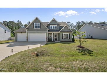 Charming two-story home featuring an attached two-car garage and a well-maintained lawn at 178 Ashpole Trl, Clayton, NC 27520