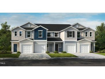 Charming townhome exterior with attached garages, neutral siding, and well-maintained landscaping at 2003 Oakdale Dr, Durham, NC 27704