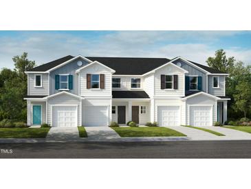Beautiful new construction townhomes with attached garages and manicured lawns at 2015 Oakdale Dr, Durham, NC 27703