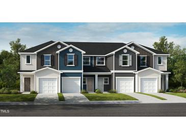 Modern townhome exterior showcasing a private garage and neutral color palette at 2027 Oakdale Dr, Durham, NC 27703