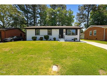Charming, freshly painted home with a well-manicured lawn and inviting curb appeal at 2311 Wintergreen Pl, Durham, NC 27707