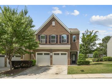 Beautiful two-story brick home with a two-car garage and well-manicured landscaping at 245 Kylemore Cir, Cary, NC 27513