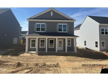 New two-story home featuring a charming front porch with white columns and gray siding at 2868 Quarry Rd # 167, Rolesville, NC 27571