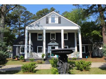 Charming two-story home with a covered porch and landscaped front yard at 300 S Pine St, Benson, NC 27504