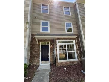 Charming townhome featuring a stone facade and well-maintained landscaping at 351 Gilman Ln # 109, Raleigh, NC 27610