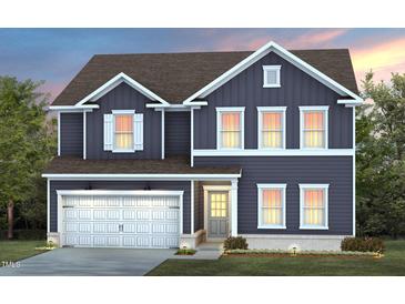 Charming two-story home with blue siding, white trim, and a well-manicured lawn at 413 Providence Springs Ln, Fuquay Varina, NC 27526
