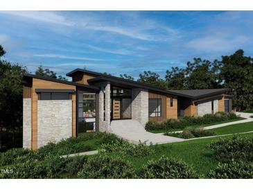 Stunning modern home with wood and stone exterior, mature landscaping, and custom entryway steps at 481 Brook Green Ln # 23, Pittsboro, NC 27312