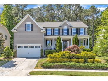 Charming two-story home with a well-manicured front yard and attached two-car garage at 533 Opposition Way, Wake Forest, NC 27587