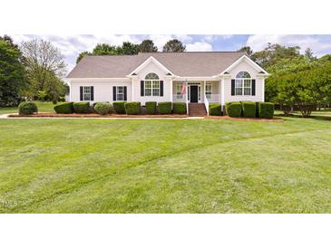 Charming single-story home with manicured lawn and inviting front porch, perfect for relaxing and enjoying the outdoors at 608 Elin Ct, Hillsborough, NC 27278