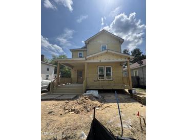Charming home featuring a covered porch, a classic gable roof, and unfinished landscaping at 618 Price Ave, Durham, NC 27701