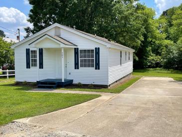 Charming single-story home with white siding, blue shutters, and a well-maintained front yard at 703 W Church St, Angier, NC 27501