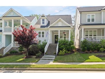 Charming home with landscaped front yard, welcoming front porch, and inviting curb appeal at 706 Great Ridge Pkwy, Chapel Hill, NC 27516