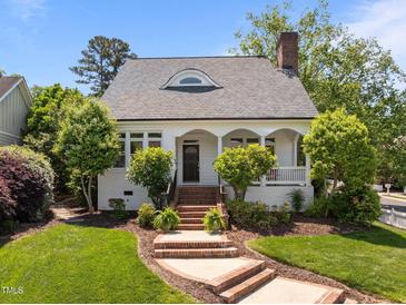Charming home with a well-manicured lawn and inviting brick steps leading to the front door at 10003 Fountain, Chapel Hill, NC 27517