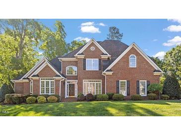Charming two-story brick home with a manicured lawn and mature trees at 112 Glenspring Way, Morrisville, NC 27560