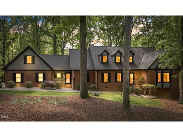 Charming brick home with well-manicured lawn and mature trees at 12537 Birchfalls Dr, Raleigh, NC 27614