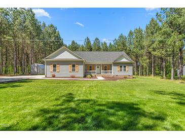 Charming single-story home featuring gray siding, symmetrical facade, and well-manicured lawn surrounded by mature trees at 1840 Willie Pace Rd, Burlington, NC 27217