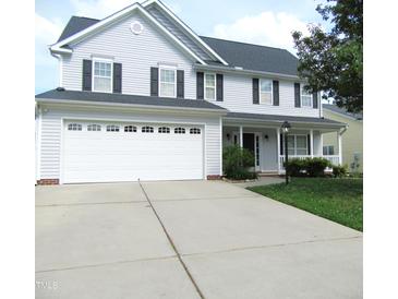 Charming two-story home with a two-car garage and well-maintained landscaping, perfect for Gathering living at 202 Redstone Ct, Gibsonville, NC 27249