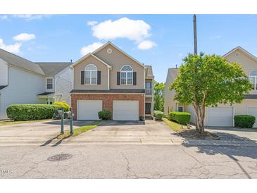 Charming two-story home with a brick facade, two-car garage, and well-manicured lawn at 2105 Metacomet Way, Raleigh, NC 27604