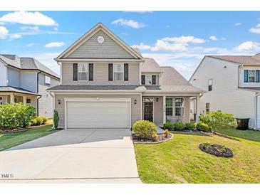 Inviting two-story home featuring a well-maintained lawn and attached two-car garage at 220 Outwater Ridge Dr, Garner, NC 27529