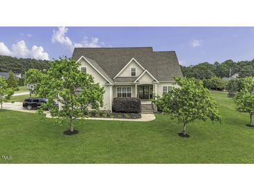 Charming two-story home with a well-manicured lawn and lush landscaping at 25 Westbourne Ln, Youngsville, NC 27596