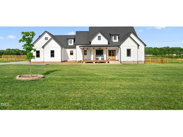 Charming two-story home features a spacious lawn, white siding, black roof, and inviting front porch at 2775 Eagles Roost Trl, Burlington, NC 27217
