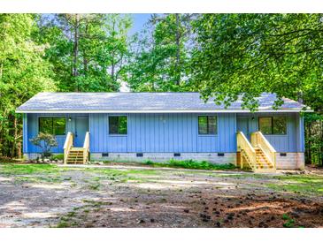 Charming one-story home featuring wood accents and a wooded lot at 327 Woodbridge Dr, Chapel Hill, NC 27516