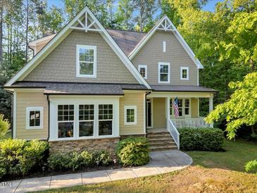 Charming two-story home featuring a welcoming front porch, attractive stone accents, and beautifully manicured landscaping at 3650 Brooks Bnd, Franklinton, NC 27525