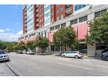 Modern high-rise building featuring covered storefronts and tree-lined street at 400 W North St # 1430, Raleigh, NC 27603