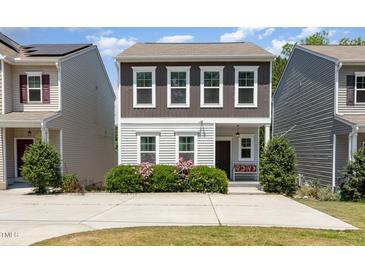 Charming two-story home with landscaped yard, inviting front porch, and a well-maintained lawn, perfect for curb appeal at 420 Cherry St, Fuquay Varina, NC 27526