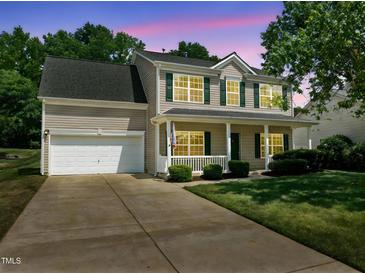 Charming two-story home with green shutters, covered porch, and well-maintained lawn at 4805 Ayden Mill Rd, Apex, NC 27539