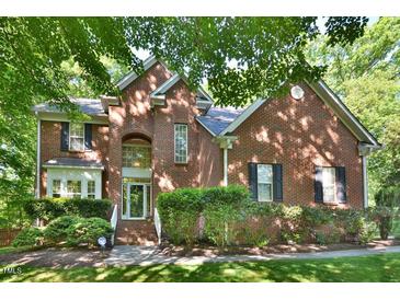 Charming two-story brick home featuring a well-manicured lawn and professional landscaping at 5 Burgess Ct, Hillsborough, NC 27278