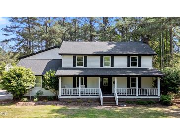 Charming two-story home with a covered front porch and mature trees at 512 Stratford Dr, Zebulon, NC 27597