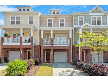 Charming townhome exterior with brick accents, inviting porches, and well-manicured landscaping at 710 Samuel Cary Dr, Cary, NC 27511