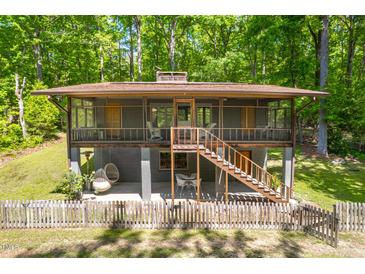 Charming two-story home featuring a screened-in porch and wooded backyard views at 7723 Johnson Mill Rd, Bahama, NC 27503