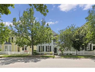 Charming two-story home with white picket fence, beautiful tree and well maintained yard at 815 Carpenter Town Ln, Cary, NC 27519
