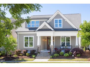 Charming home exterior featuring a covered porch, stone accents, and well-maintained landscaping at 92 Cardinal Ridge Rd, Chapel Hill, NC 27516