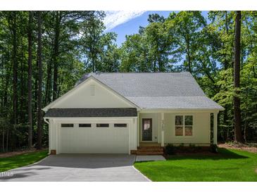 Charming home featuring an attached garage, well-manicured lawn, and inviting front entrance at Lot 3260 Yorkshire Cir, Sanford, NC 27332