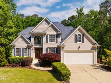 Charming two-story home featuring a manicured lawn and a two-car garage at 100 Panoramic Ct, Cary, NC 27519
